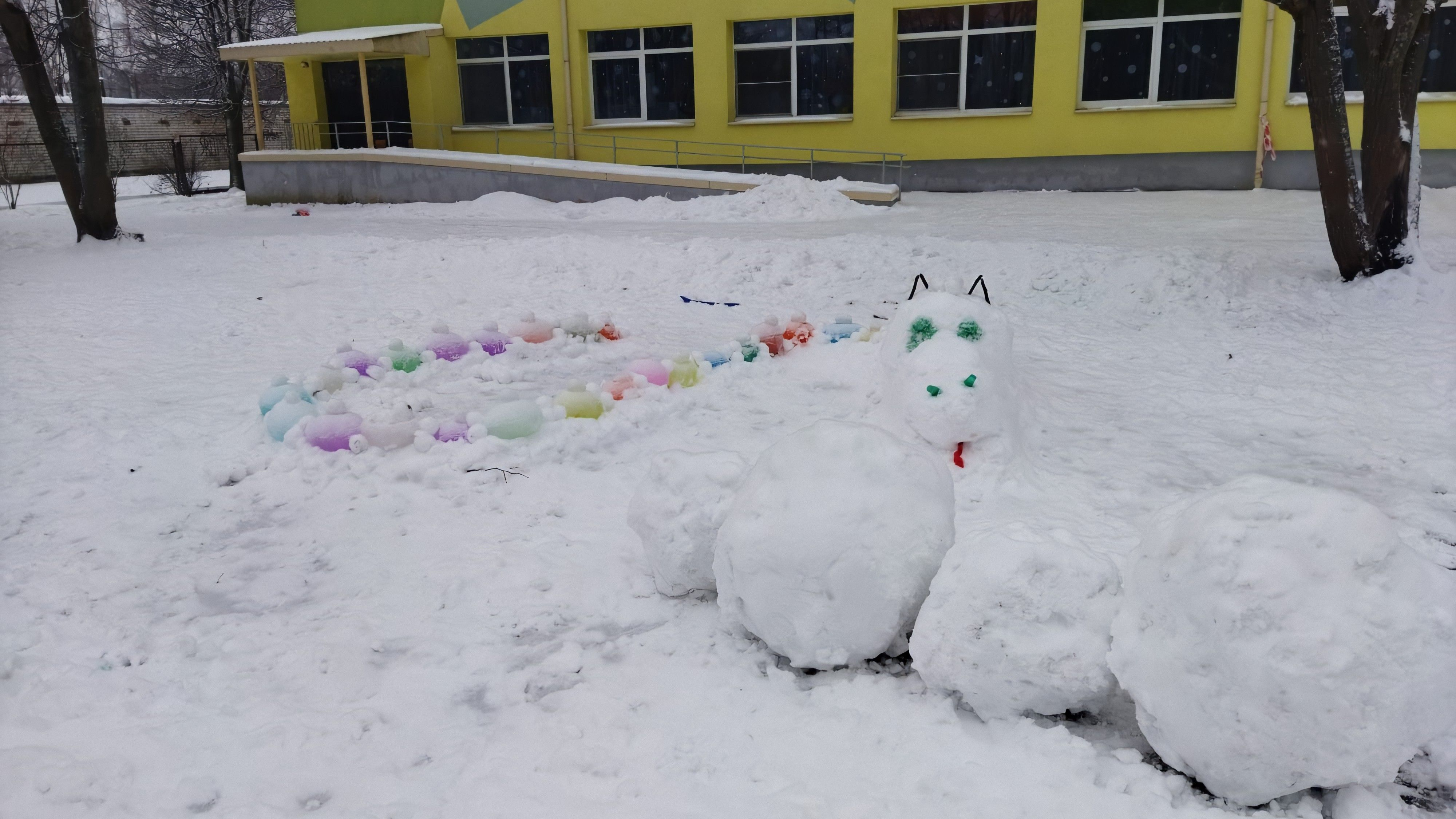 No sniega bumbām veidots pūķis bērnudārza 
